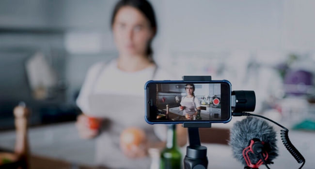 Girl filming video in kitchen