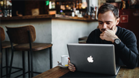 man-reading-on-laptop