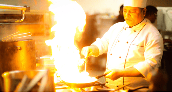 Chef with flaming pan