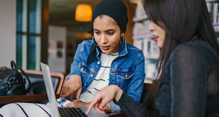 two female working on laptop