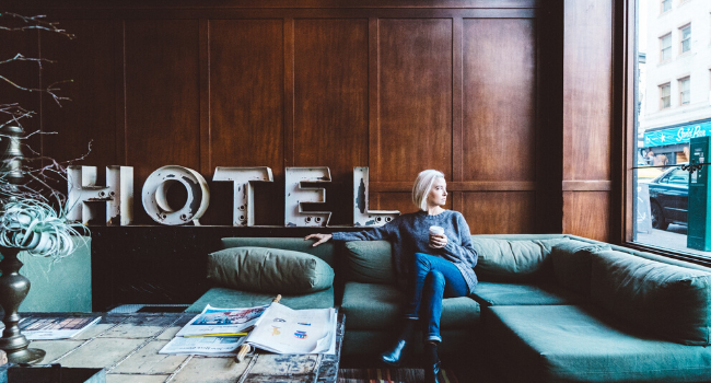 Girl in hotel drinking coffee