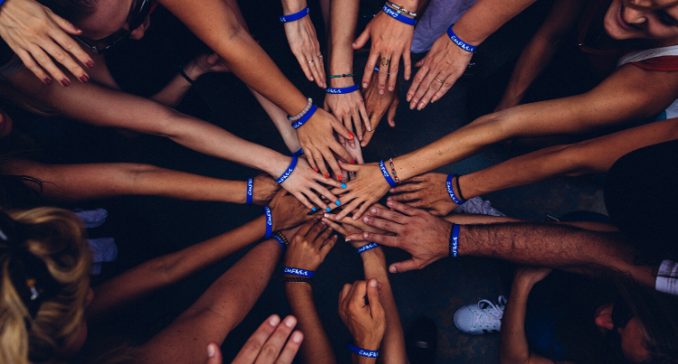 people-putting-hands-together-in-celebration