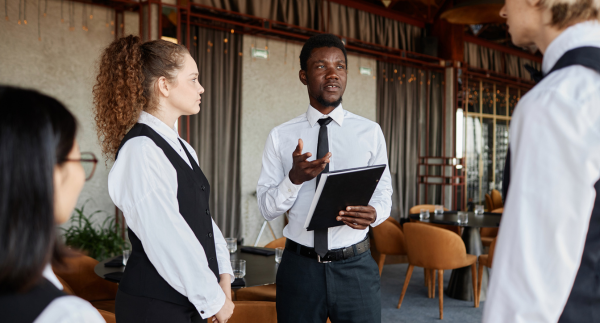 Restaurant manager training staff before shift