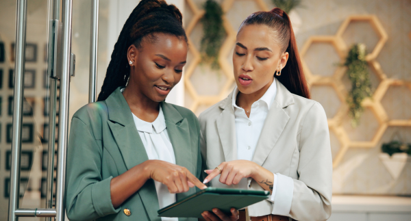 hospitality manager using tablet to train team member