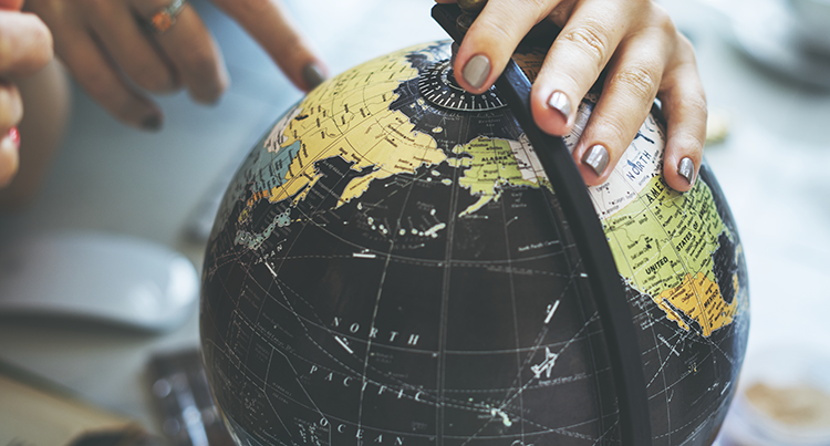 girl pointing to world map